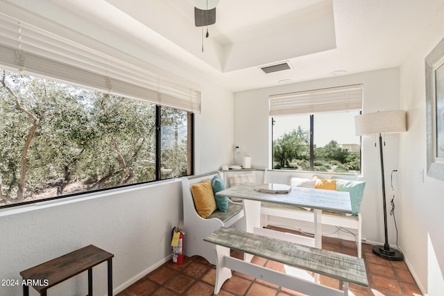 interior space with a tray ceiling and ceiling fan