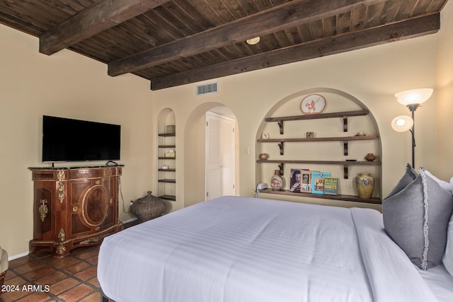 bedroom with dark tile floors, wood ceiling, and beamed ceiling