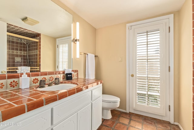 bathroom with vanity, tile floors, backsplash, and toilet