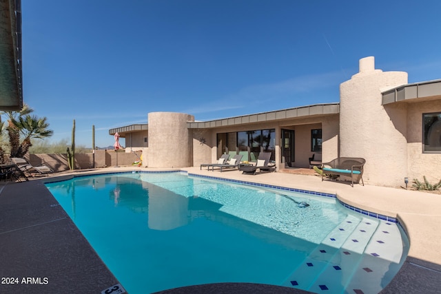 view of swimming pool featuring a patio area