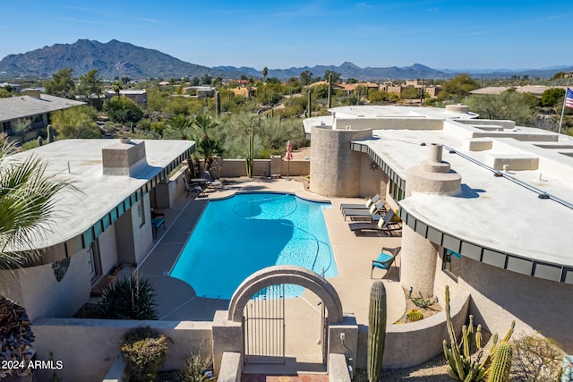 view of swimming pool with a mountain view and a patio