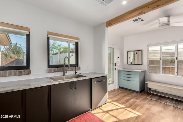 kitchen with dishwasher, sink, dark brown cabinetry, beam ceiling, and light hardwood / wood-style flooring