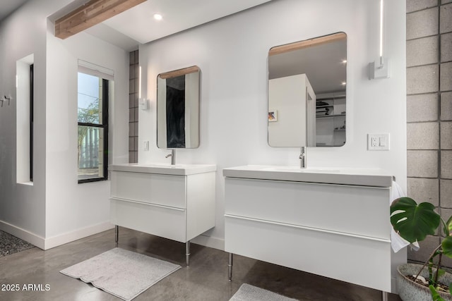 bathroom with vanity and concrete flooring