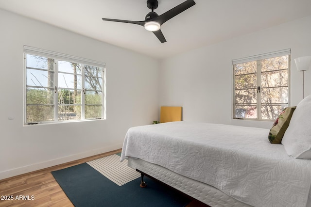 bedroom with wood-type flooring and ceiling fan