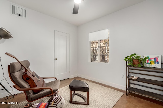 sitting room featuring ceiling fan