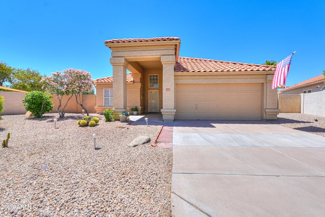 mediterranean / spanish-style home with a garage