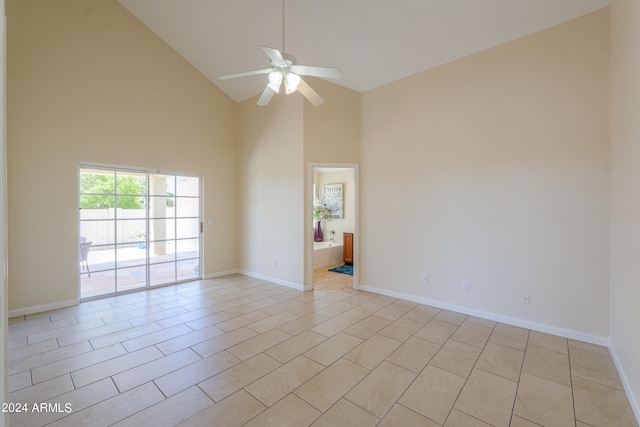 tiled spare room with high vaulted ceiling and ceiling fan