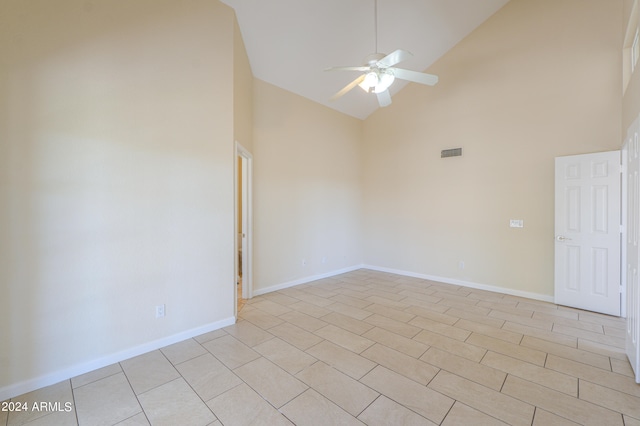 unfurnished room featuring ceiling fan, high vaulted ceiling, and light tile floors