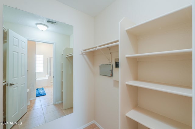 spacious closet featuring light tile flooring