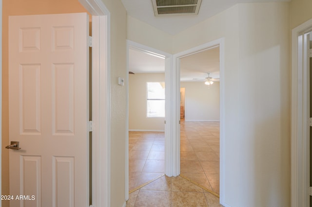 corridor featuring light tile flooring