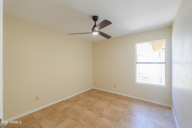 unfurnished room with ceiling fan and light tile floors