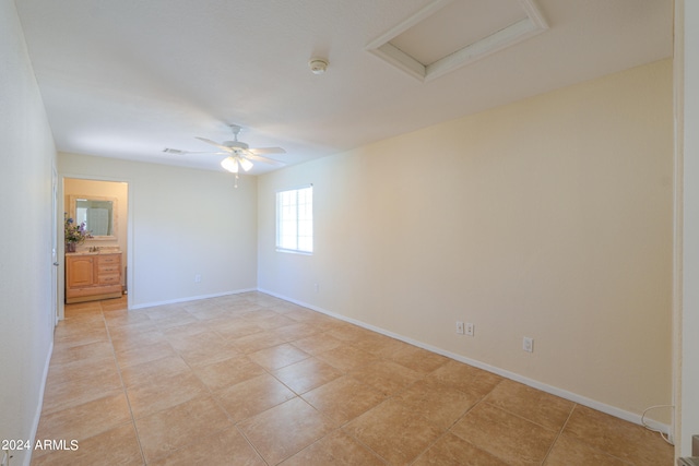 tiled spare room with ceiling fan