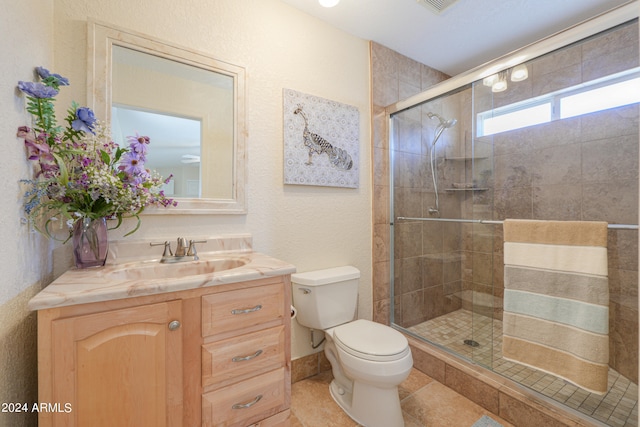 bathroom with an enclosed shower, toilet, tile flooring, and vanity