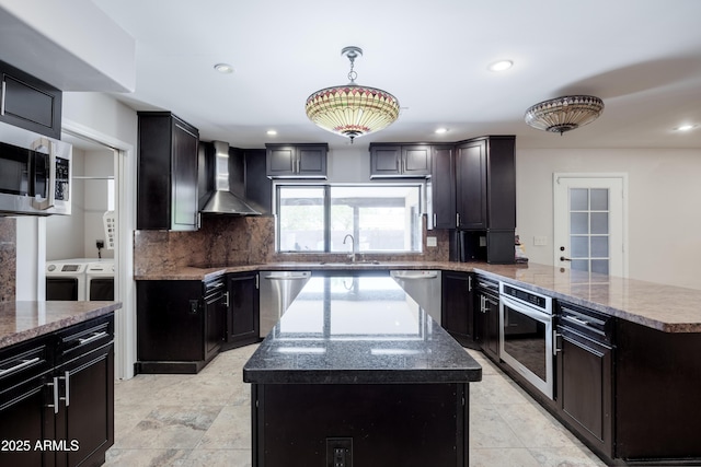 1551 E Glencove St, Mesa, AZ 85203 - kitchen featuring wall chimney range hood, washer and clothes dryer, appliances with stainless steel finishes, a peninsula, and a center island