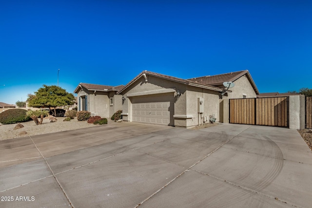 ranch-style home with a garage, concrete driveway, a tiled roof, and stucco siding