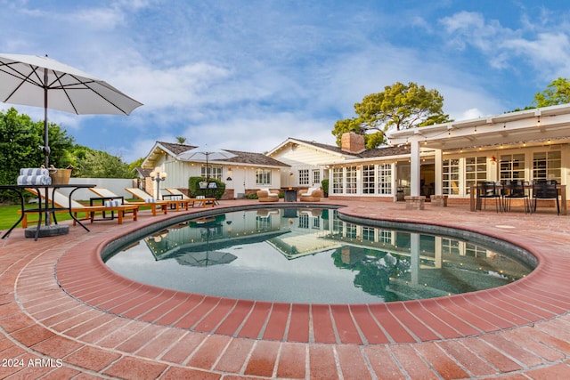 view of swimming pool featuring a patio and french doors