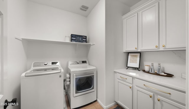 10224 E Talameer Ave, Mesa, AZ 85212 - laundry area featuring washing machine and clothes dryer, cabinet space, and light tile patterned floors