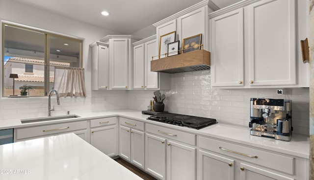 10224 E Talameer Ave, Mesa, AZ 85212 - kitchen with a sink, black stovetop, tasteful backsplash, white cabinets, and recessed lighting