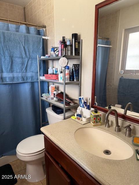 bathroom with vanity, tile patterned floors, curtained shower, and toilet