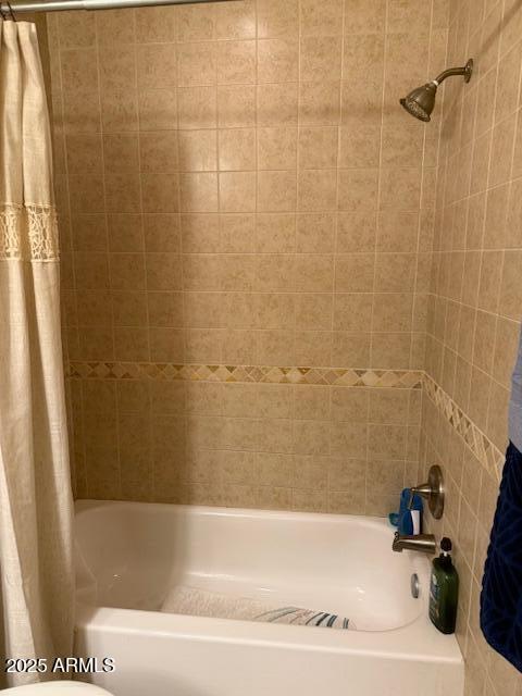 bathroom featuring shower / tub combo with curtain