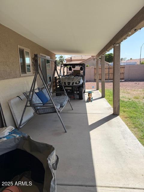 view of patio featuring fence