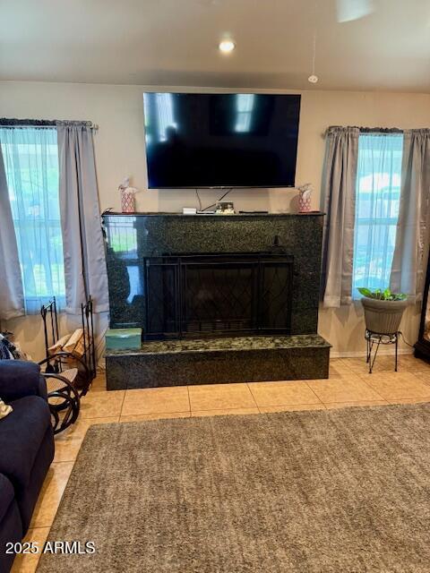 interior details with recessed lighting and a fireplace with raised hearth