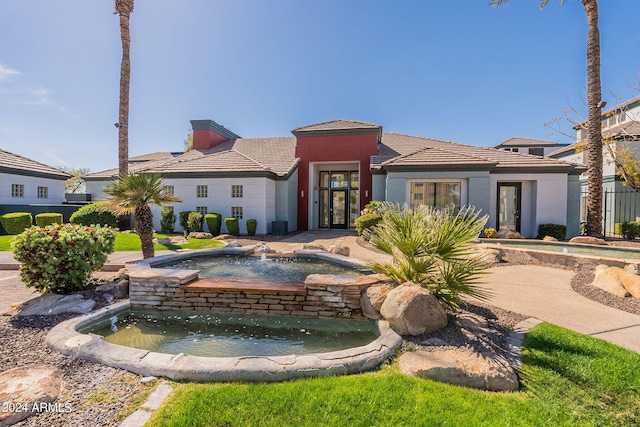 view of front of property with an in ground hot tub