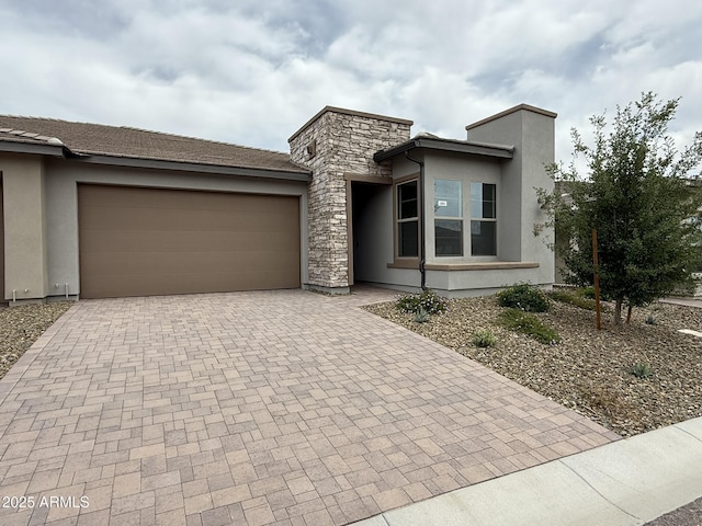 4128 Desert Moon Dr, Wickenburg, AZ 85390 - view of front of home featuring decorative driveway, a garage, and stucco siding