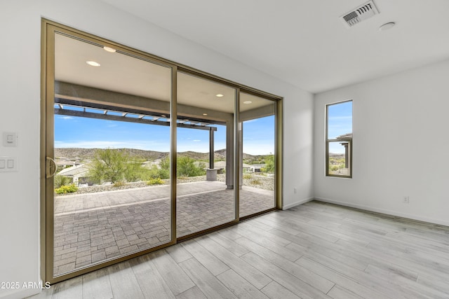 4128 Desert Moon Dr, Wickenburg, AZ 85390 - spare room featuring wood finished floors, a mountain view, recessed lighting, and baseboards