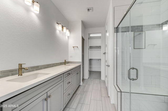 4128 Desert Moon Dr, Wickenburg, AZ 85390 - full bath featuring a stall shower, a spacious closet, double vanity, and tasteful backsplash
