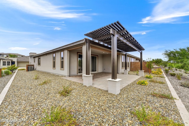 4128 Desert Moon Dr, Wickenburg, AZ 85390 - back of house with stucco siding, a pergola, a patio, and central air condition unit