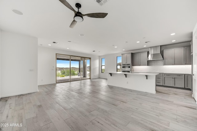 4128 Desert Moon Dr, Wickenburg, AZ 85390 - unfurnished living room with a ceiling fan, recessed lighting, light wood-style flooring, and baseboards