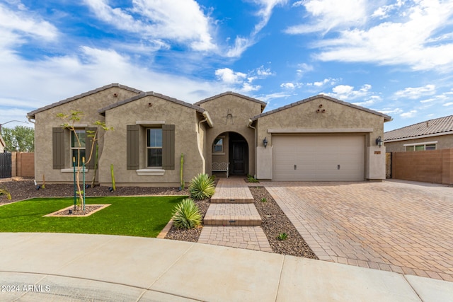 view of front of home featuring a front lawn and a garage