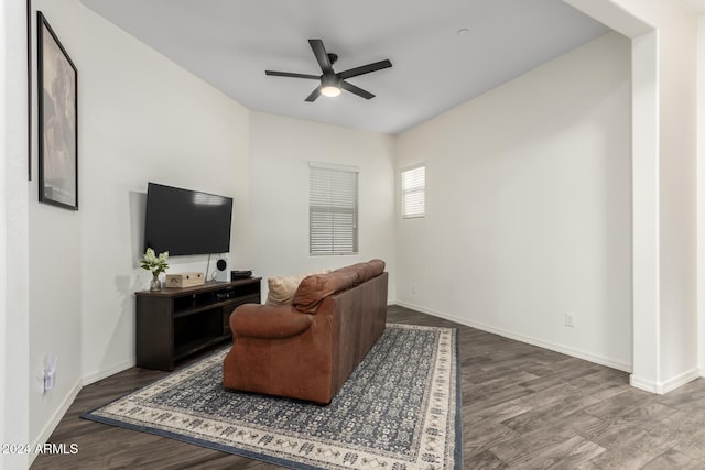 living room featuring wood-type flooring and ceiling fan