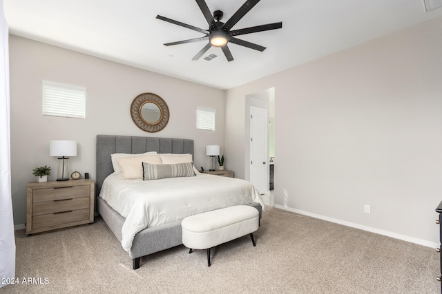 carpeted bedroom with multiple windows and ceiling fan