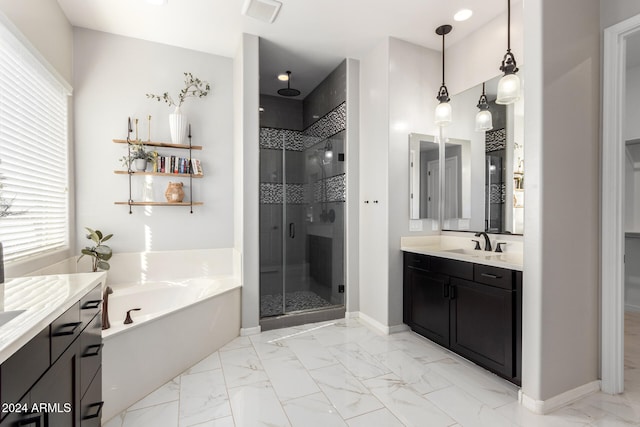 bathroom featuring vanity, plenty of natural light, and shower with separate bathtub