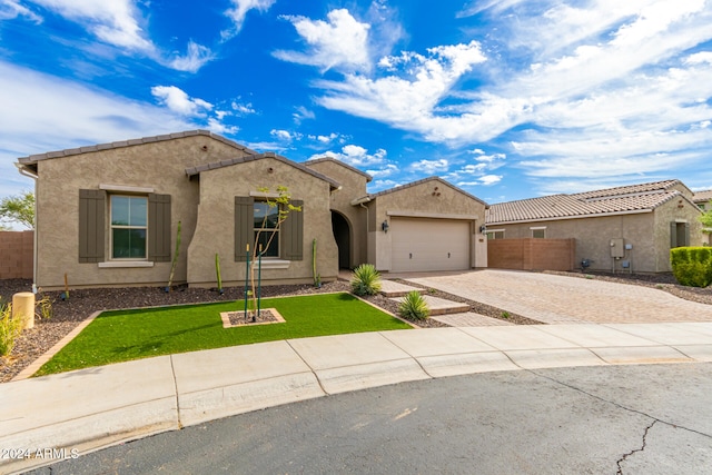 view of front of home with a garage and a front yard