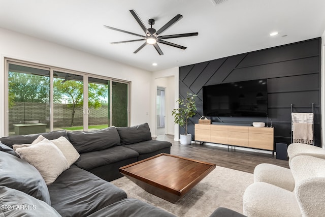 living room featuring hardwood / wood-style floors and ceiling fan