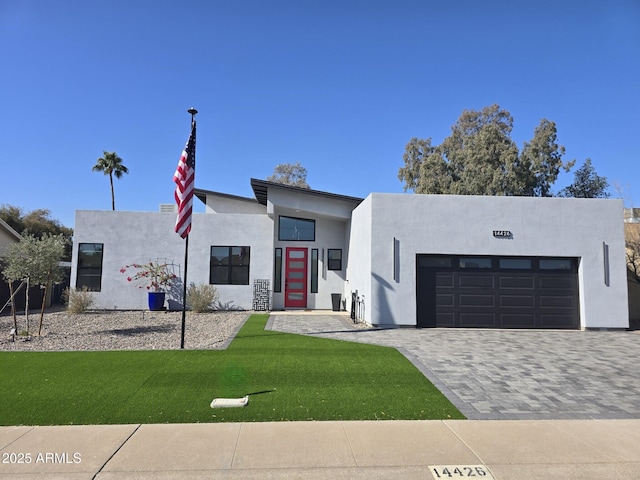 view of front of home featuring a garage and a front lawn