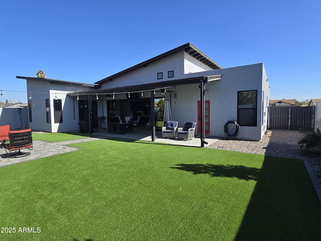 back of house with a lawn and a patio area