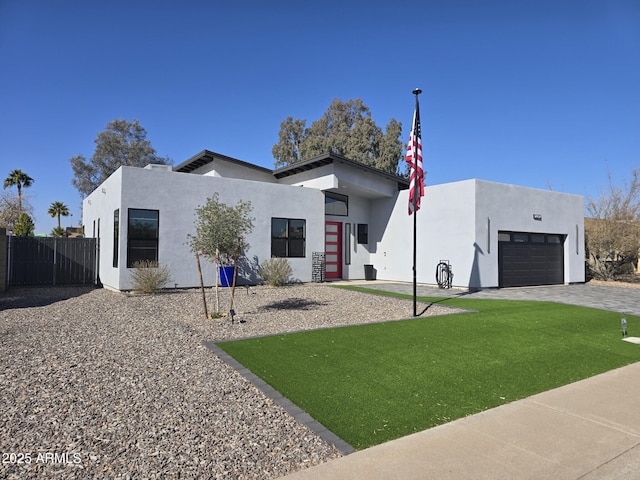 contemporary home featuring a garage and a front yard