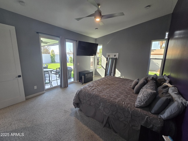 carpeted bedroom with multiple windows, lofted ceiling, access to outside, and ceiling fan