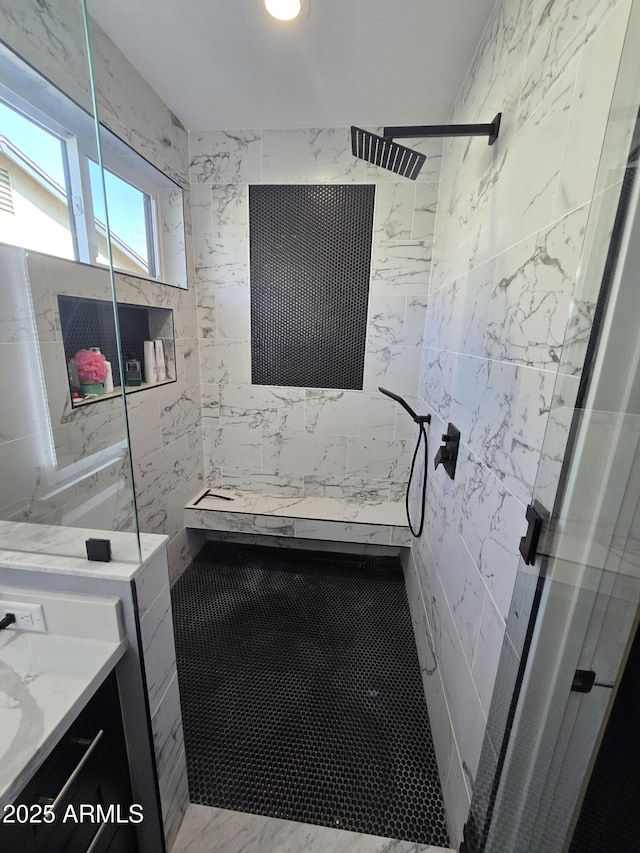 bathroom with vanity and tiled shower