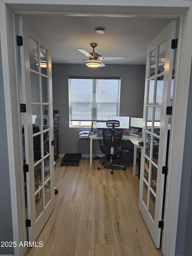 office with french doors, ceiling fan, and light hardwood / wood-style floors