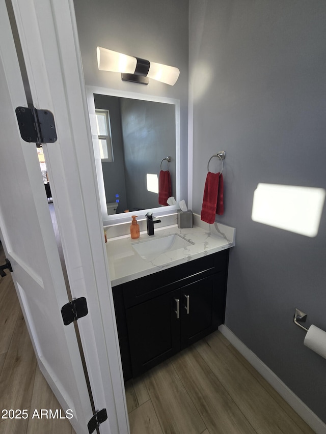 bathroom featuring wood-type flooring and vanity