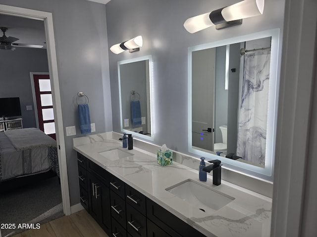 bathroom with ceiling fan, vanity, toilet, and hardwood / wood-style floors