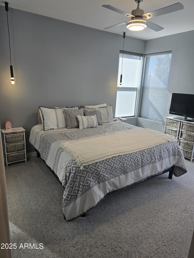 bedroom featuring ceiling fan and carpet