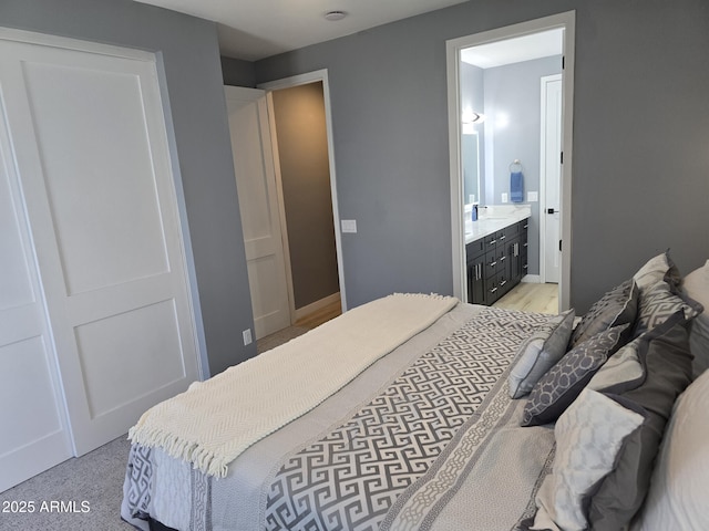 bedroom featuring sink and ensuite bath