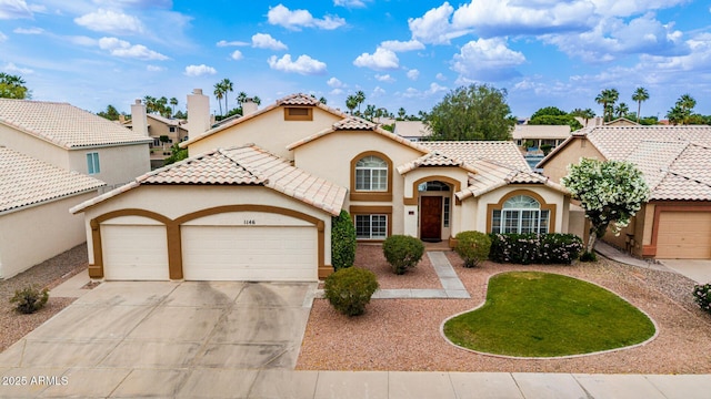 1146 W Sea Fog Dr, Gilbert, AZ 85233 - mediterranean / spanish-style house featuring stucco siding, a garage, driveway, and a tile roof