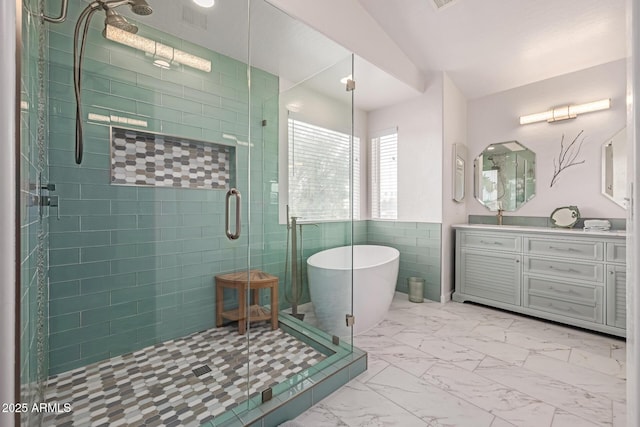 1146 W Sea Fog Dr, Gilbert, AZ 85233 - bathroom with marble finish flooring, a shower stall, vanity, a freestanding tub, and tile walls